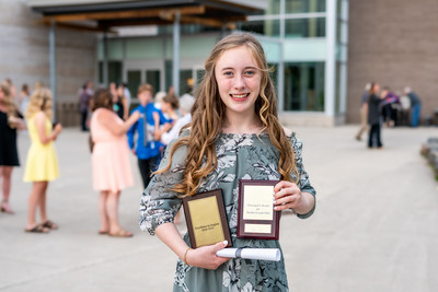 Girl holding awards